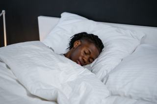 Le sommeil, premier temps de la récupération sportive Coureuse endormie au petit matin, tenue de sport posée au pied du lit
